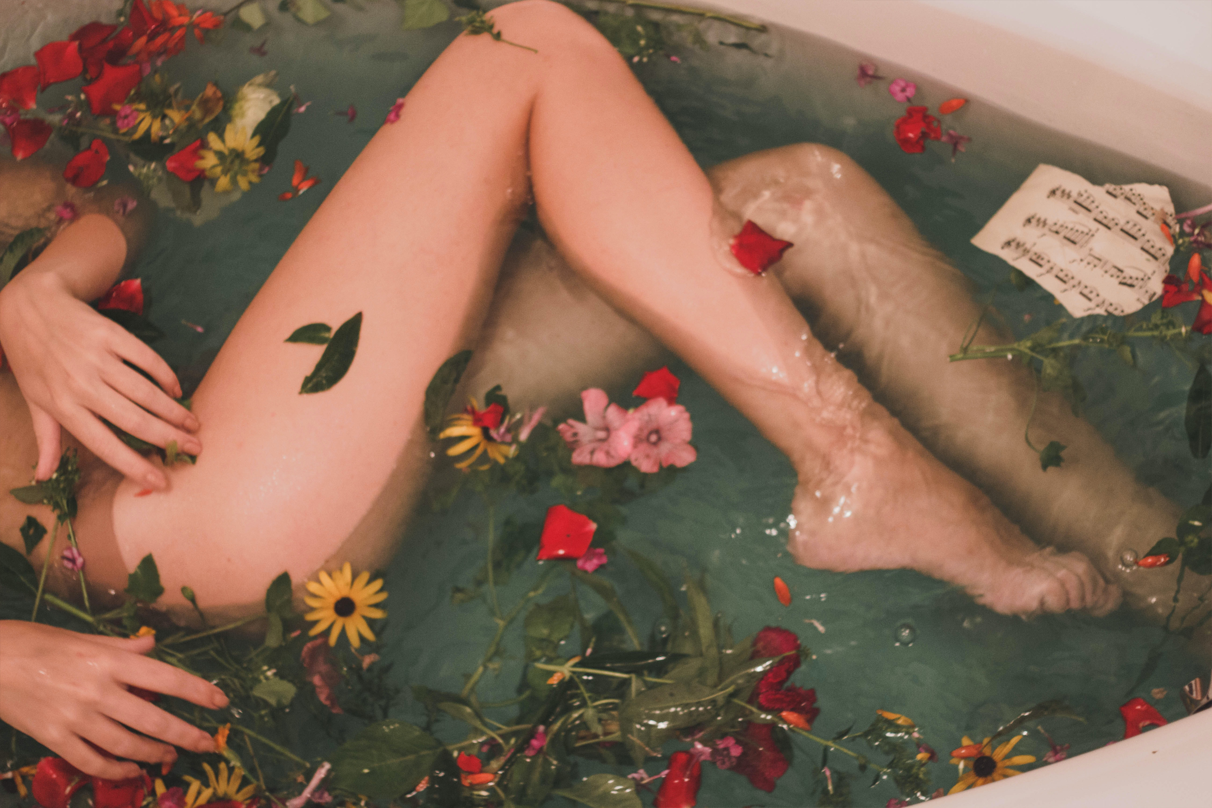 A woman relaxing in the water and flower with waxed legs
