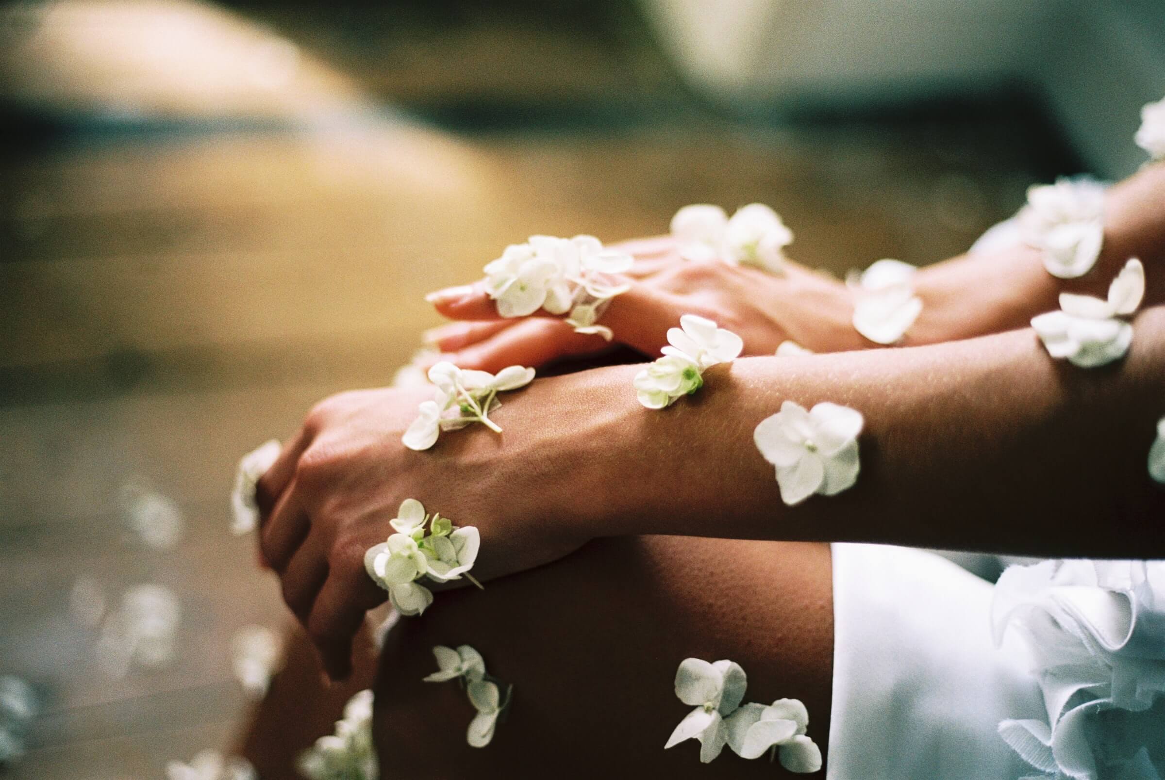 A person sitting with their hands on top of each other.